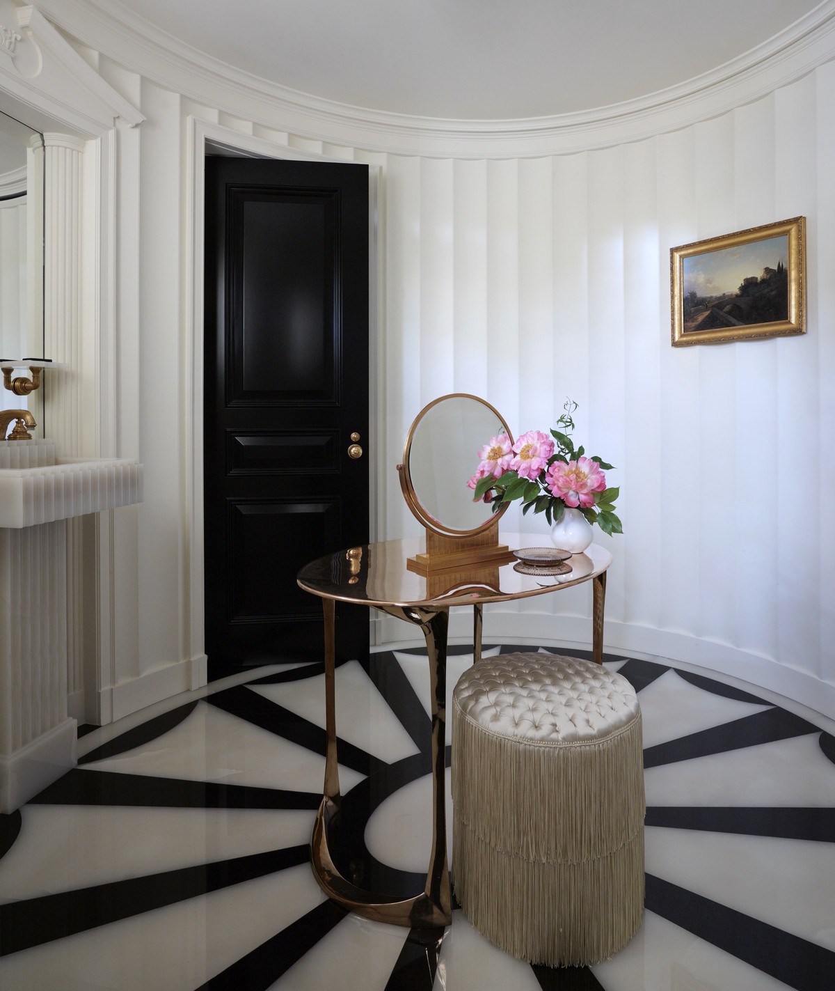 Oval powder room of 1938 Ann Rutherford house in Beverly Hills with white onyx and black marble floor