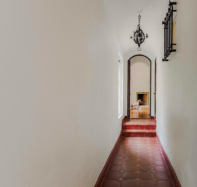 Southern California Tuscan Villa with barrel vault ceiling, wrought iron pendant and red tile floor