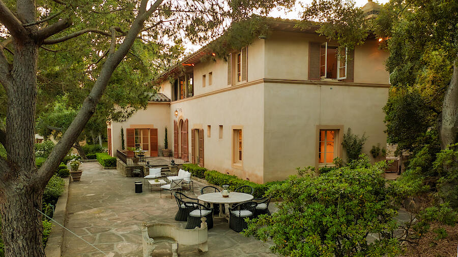 Southern California Tuscan villa wide stone terrace with multiple seating areas