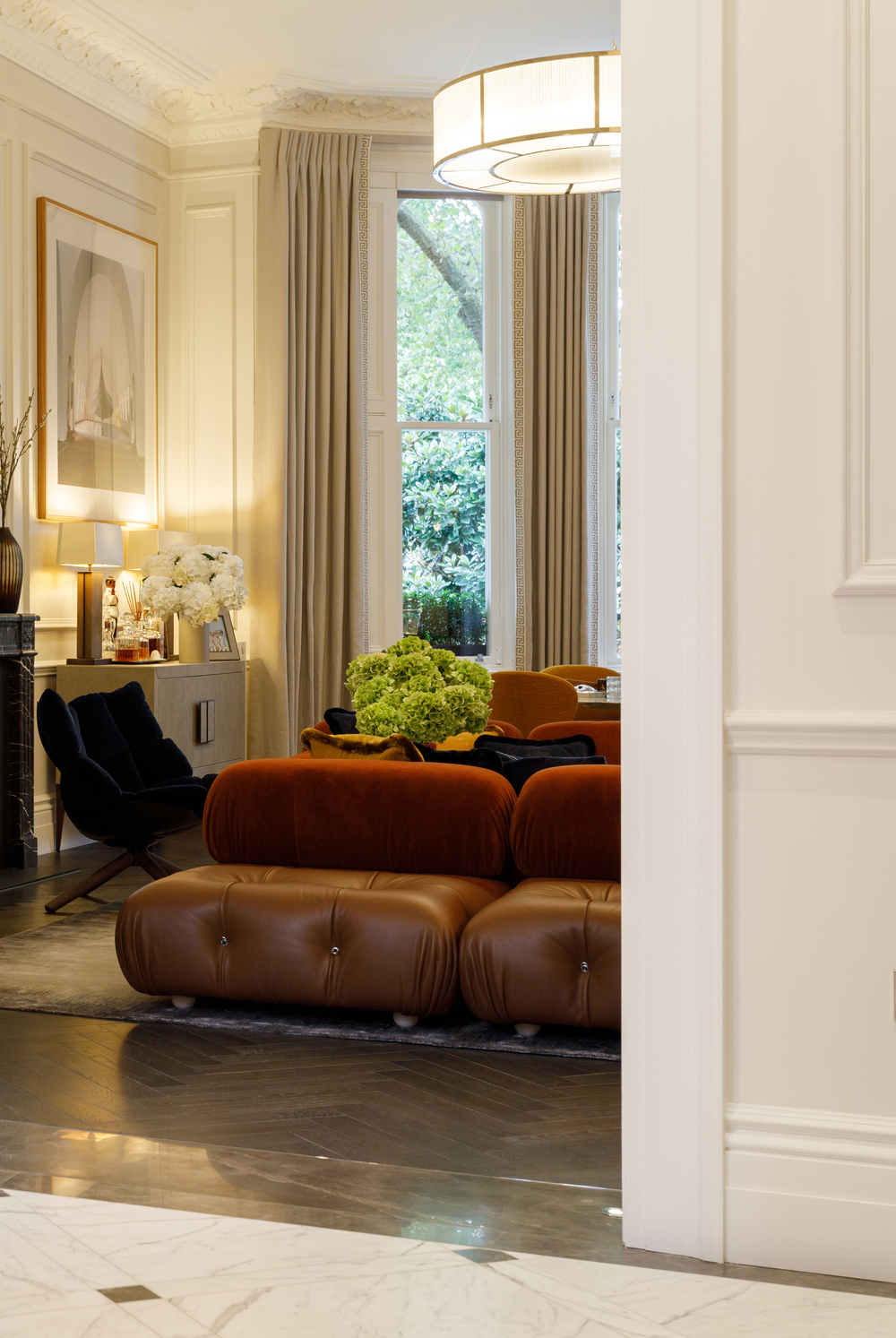 Drawing room enfilade of Grade II listed house in Ennismore Gardens, Knightsbridge, London with Mario Bellini Camaleonda sofas and Candida Höfer Wikingmuseum Oslo I, 2000