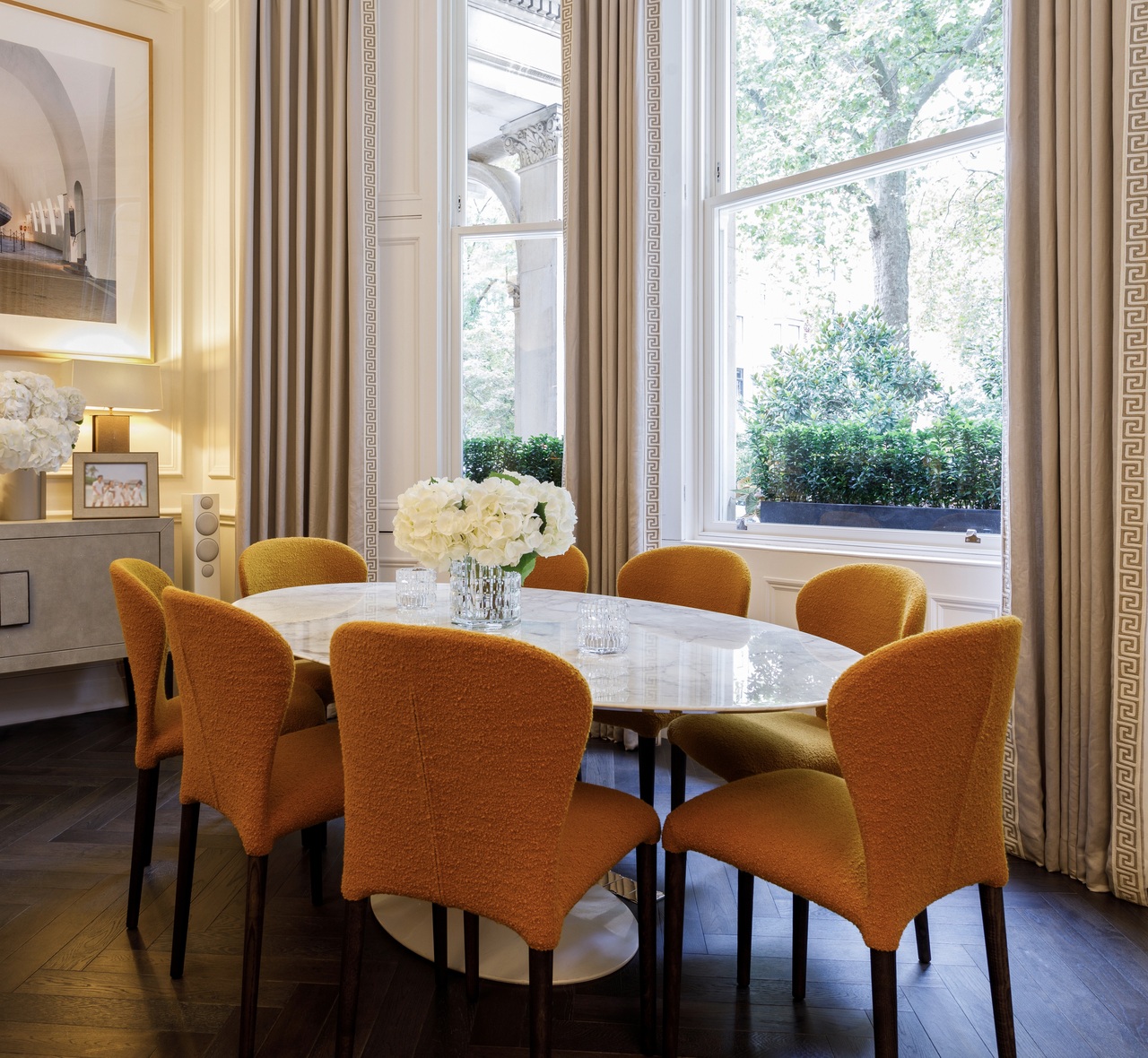 Dining room of Grade II listed house in Ennismore Gardens, Knightsbridge, London with Saarinen oval dining table and Candida Höfer Wikingmuseum Oslo I, 2000