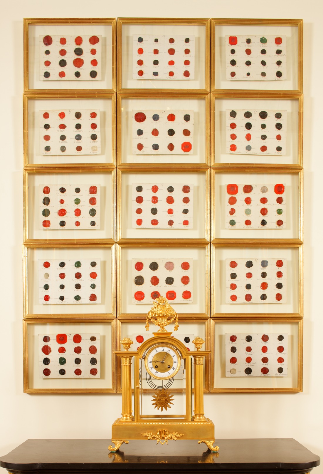 Collection of gold framed red and black wax seals