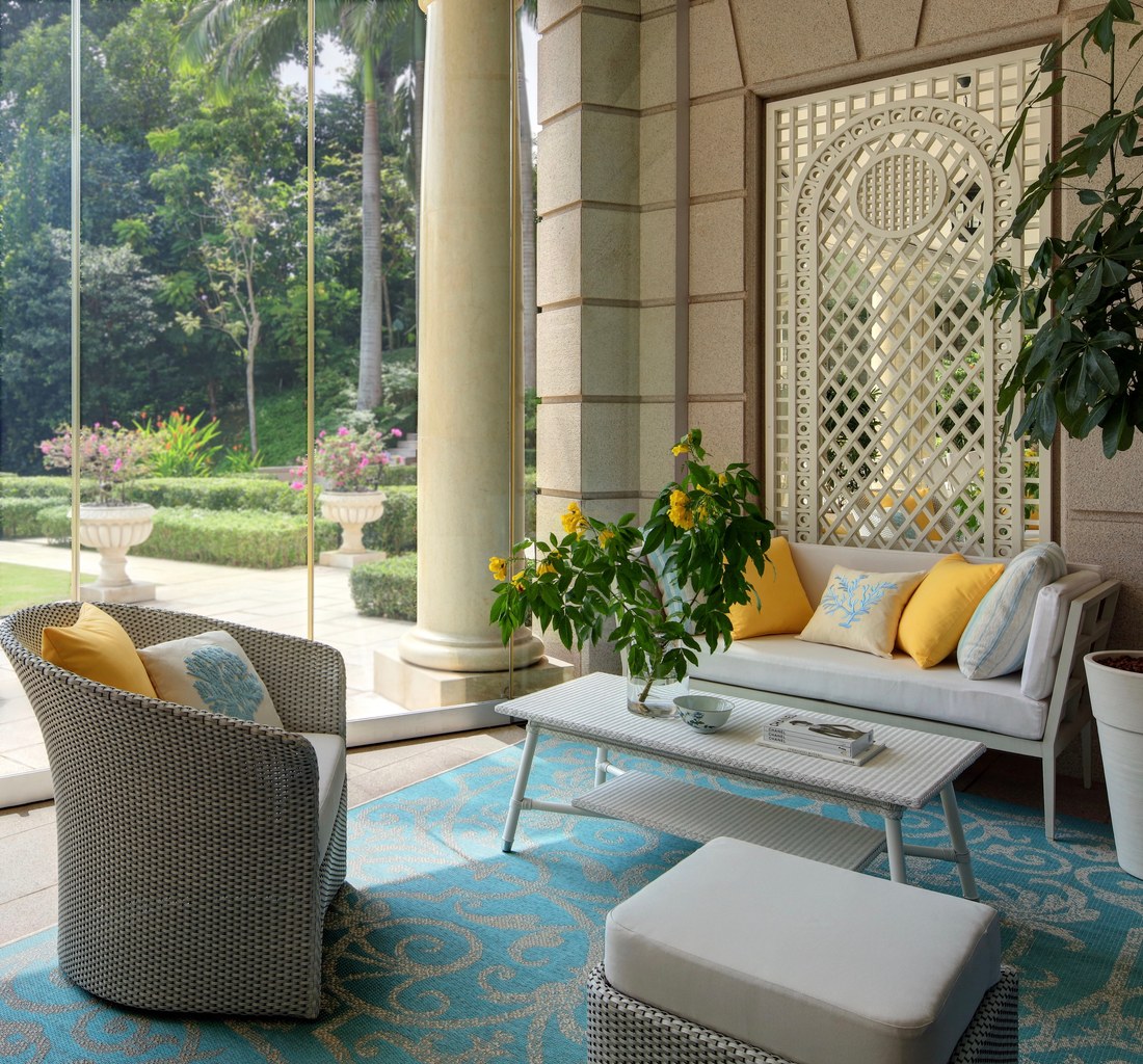 Singapore garden loggia with wicker furniture and trellis wall panel